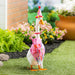 Decorative goose with a birthday hat and 'Happy Birthday' banner in an outdoor setting.