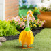 Decorative goose costume with yellow flower petals on a garden background