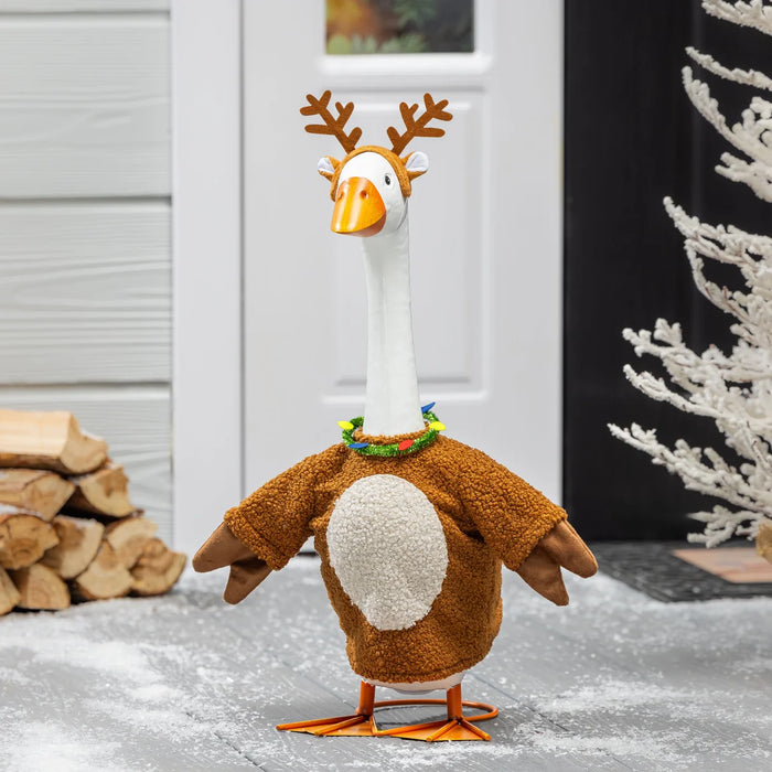Plush toy goose with reindeer antlers and costume in a snowy setting