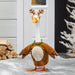 Plush toy goose with reindeer antlers and costume in a snowy setting