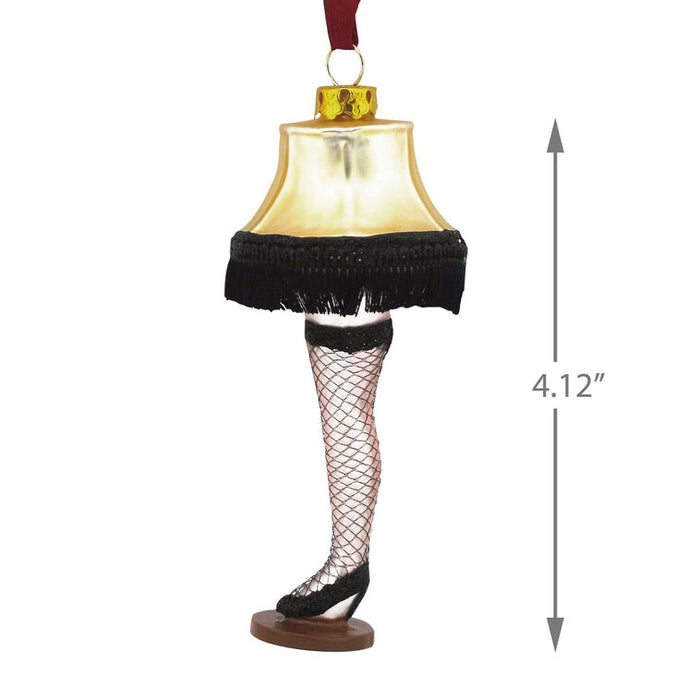 Christmas ornament shaped like a leg with a lampshade, fishnet stockings, and high heels, featuring dimensions on a white background.
