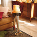 Lamp with fishnet stockings and sneakers in a living room setting
