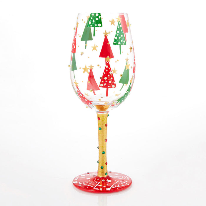 Decorative wine glass with Christmas tree design on a white background