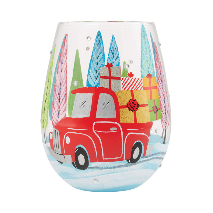 Stemless wine glass with a red truck and Christmas trees design on a white background