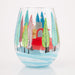 Decorative wine glass with a colorful winter scene of trees and a house on a white background