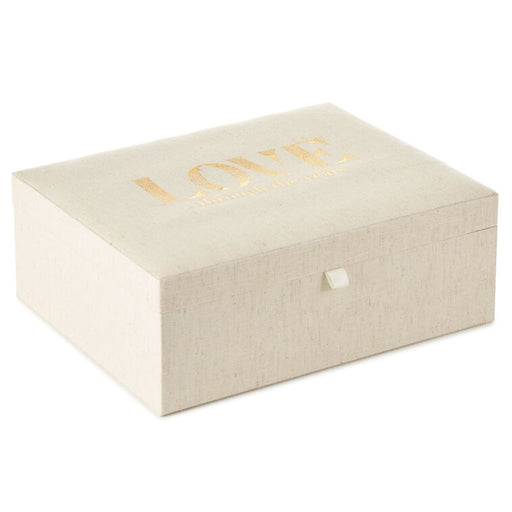 Beige jewelry box with 'LOVE' in gold on a white background