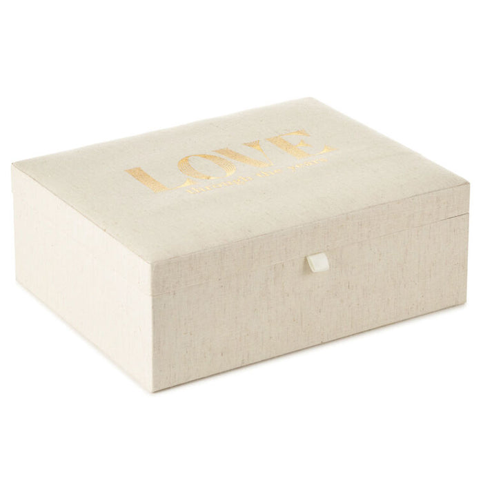 Beige jewelry box with 'LOVE' in gold on a white background