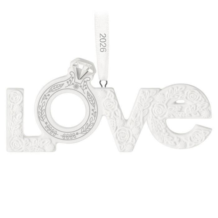 Silver 'LOVE' pendant with intricate designs on a white background