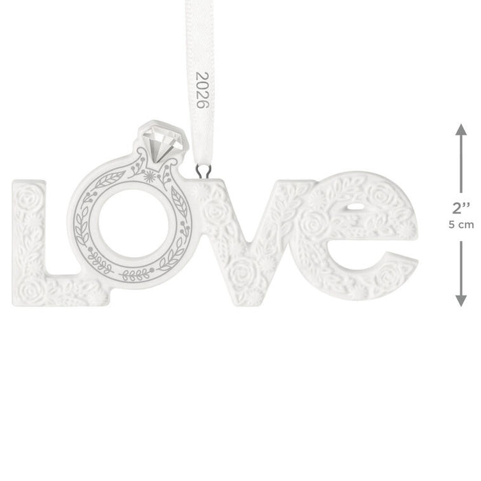 Silver 'LOVE' pendant with a diamond on a white background