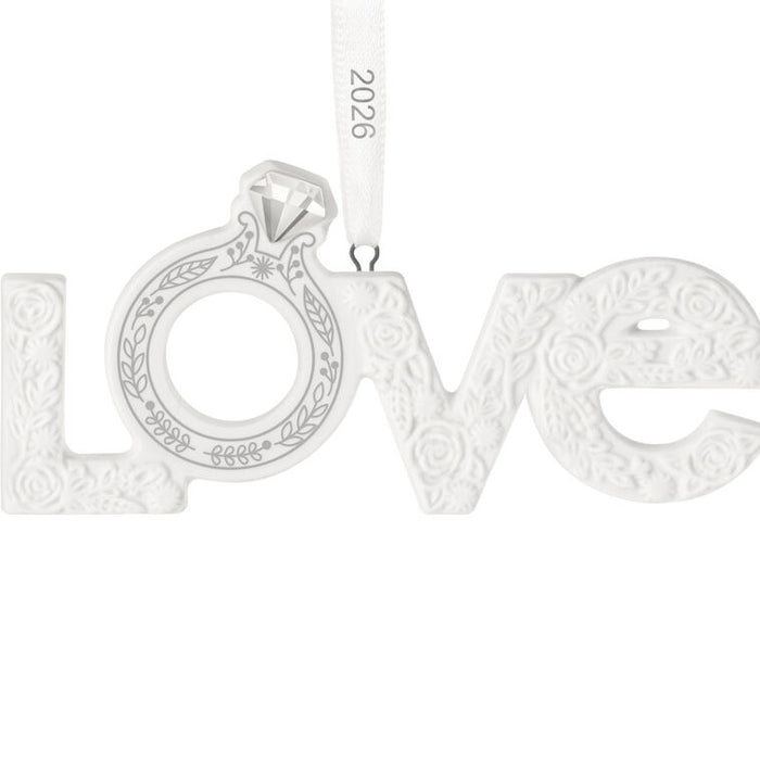 Silver 'LOVE' pendant with a diamond on a white background