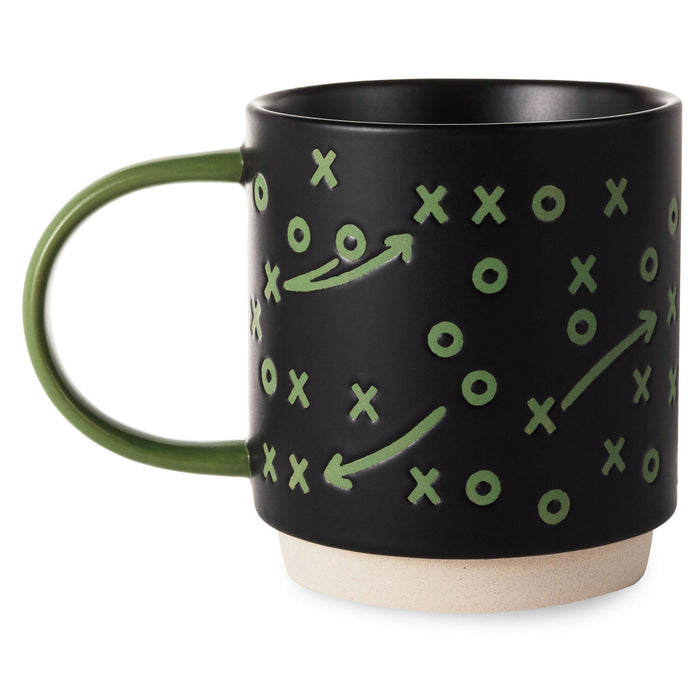 Black mug with green game plan design on a white background