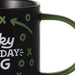 Black mug with green and white text and symbols on a white background