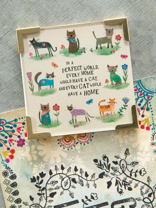 Card with cat illustrations and a quote on a textured surface