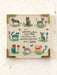 Framed artwork with illustrations of cats and a quote on a white background
