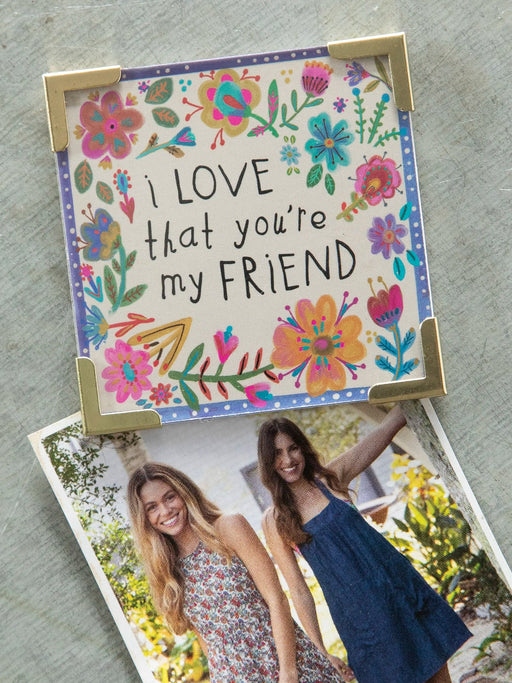 Floral card with 'I LOVE that you're my FRIEND' text and a photo of two women holding hands.