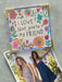 Floral card with 'I LOVE that you're my FRIEND' text and a photo of two women holding hands.