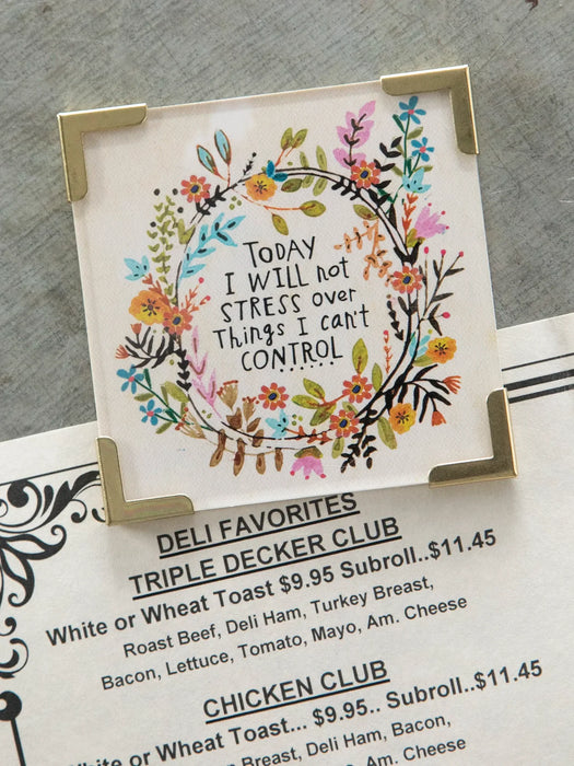 Decorative sign with floral design and motivational quote on a menu background