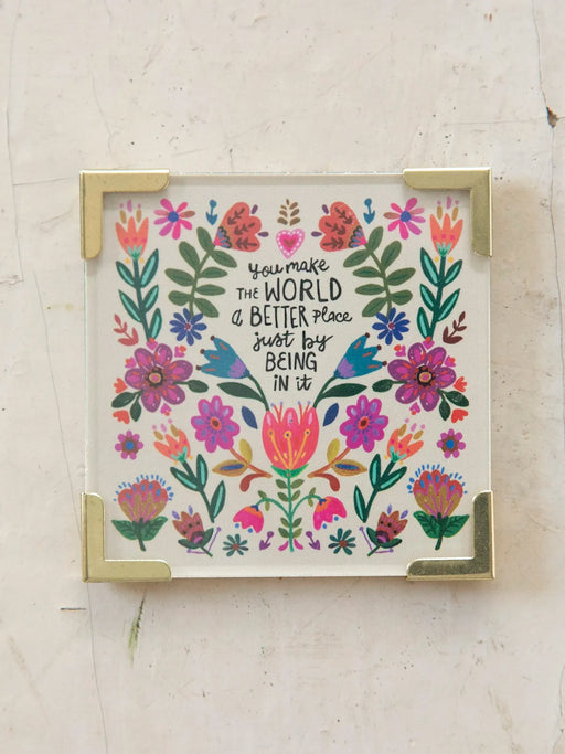 Framed artwork with floral design and motivational quote on a light background