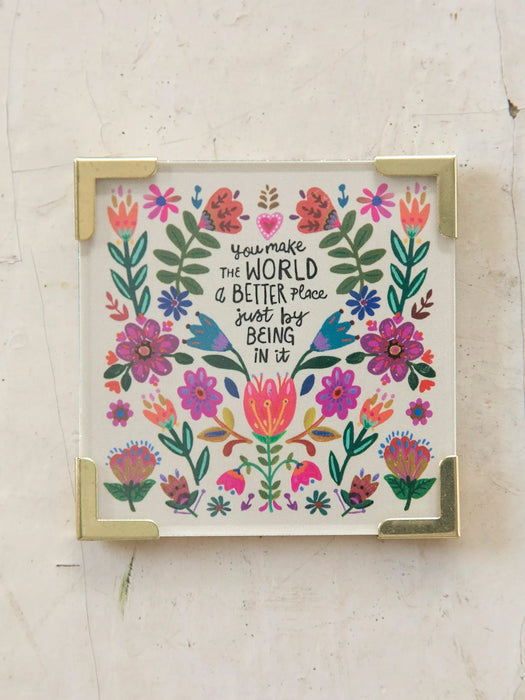 Framed artwork with floral design and motivational quote on a light background