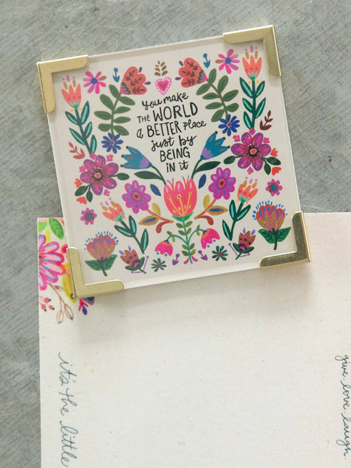 Floral card with motivational quote on a gray surface