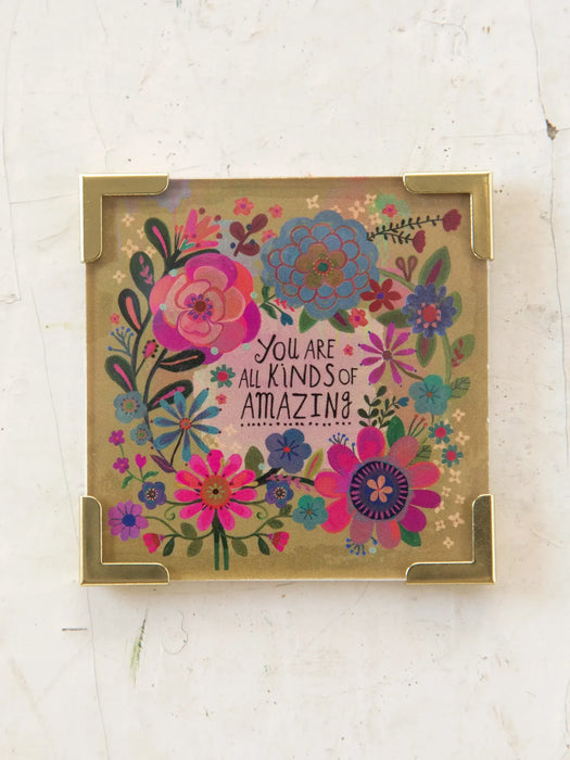 Decorative box with floral design and motivational text on a white background