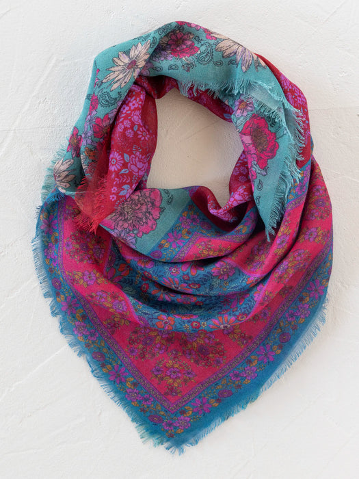 Multicolored patterned fabric with floral and abstract designs on a white background