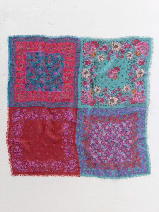 Multicolored patterned fabric with floral and abstract designs on a white background