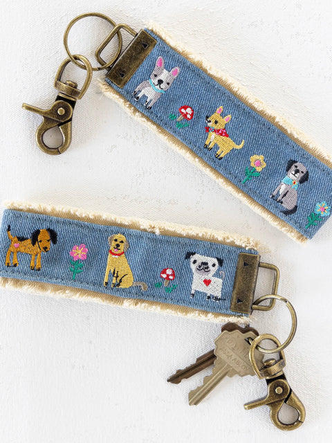 Keychain with embroidered dogs and flowers on a blue background
