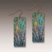 Pair of rectangular earrings with artistic tree design on a neutral background
