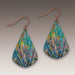 Teardrop-shaped earrings with a tree pattern on a gray background