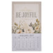 A vertical wall calendar page with a beige top section reading “always BE JOYFUL” and “January 2027,” decorated with cream flowers and green leaves, and a white lower section showing the calendar grid.