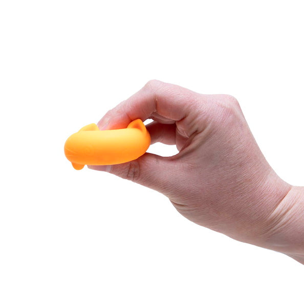 Hand holding an orange object against a white background