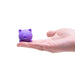 Purple cat-shaped stress reliever held in a hand on a white background