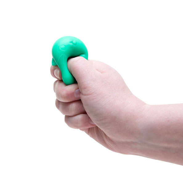 Hand holding a green stress ball against a white background