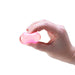 Hand holding a pink object against a white background