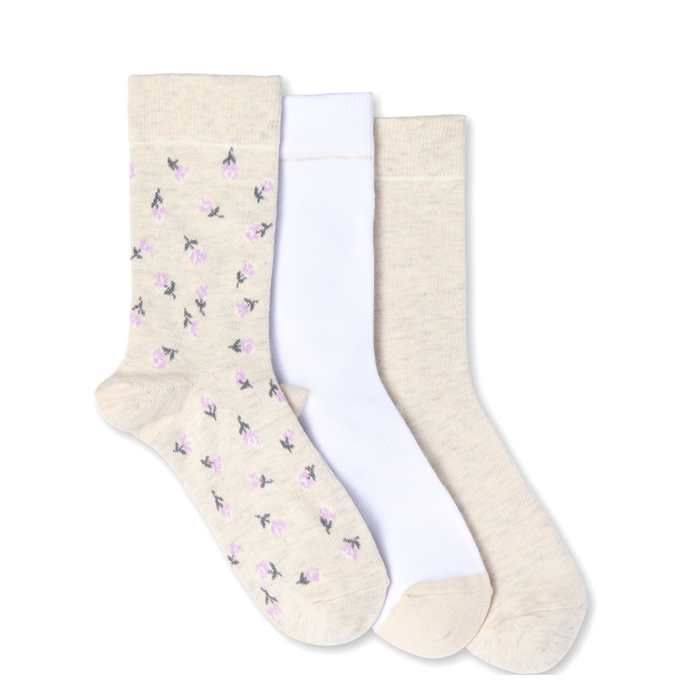 Three pairs of socks with floral patterns on a white background