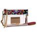 A Consuela clear plastic crossbody clutch bag with a colorful abstract patterned top band, a tan leather card holder, and a striped multicolor wristlet strap on a white background.