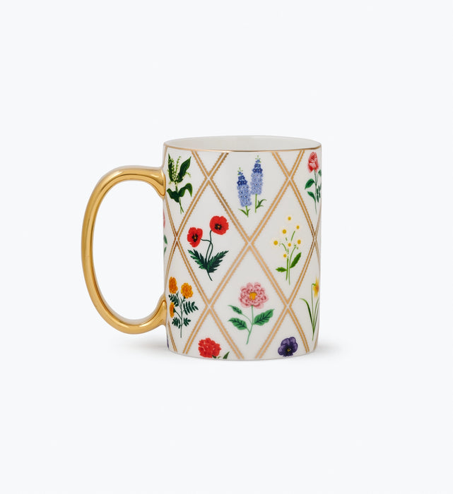Mug with floral pattern and gold handle on a white background