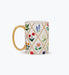 Mug with floral pattern and gold handle on a white background