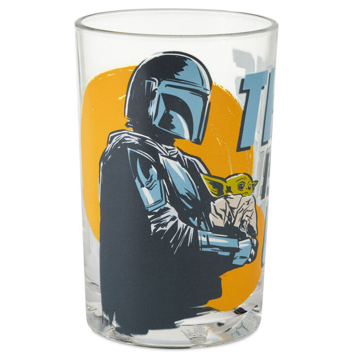 Glass tumbler with a character holding a small creature on an orange background