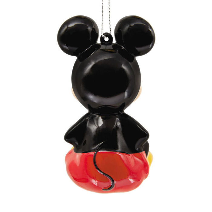 Decorative ornament shaped like a character with black ears and red body on a white background