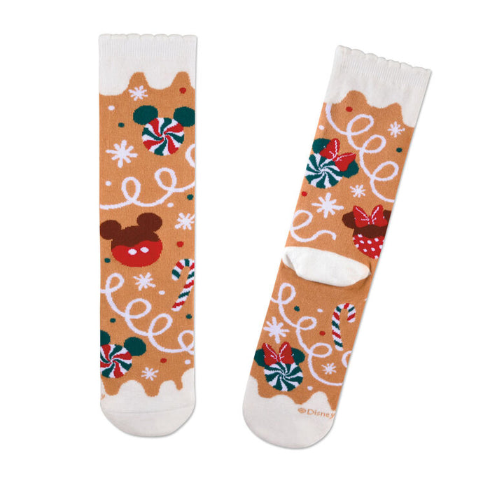 Pair of festive socks with candy cane, lollipop, and reindeer design on a white background