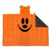 An orange plush blanket shaped like a pumpkin with a stitched vertical paneled design, a black embroidered face, and a folded-over corner revealing a dark gray underside.