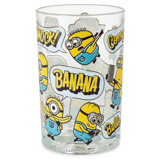 A clear glass tumbler featuring a repeating cartoon Minion print with speech bubbles and bold text including 'BANANA' and 'COMEDY', shown on a plain white background.