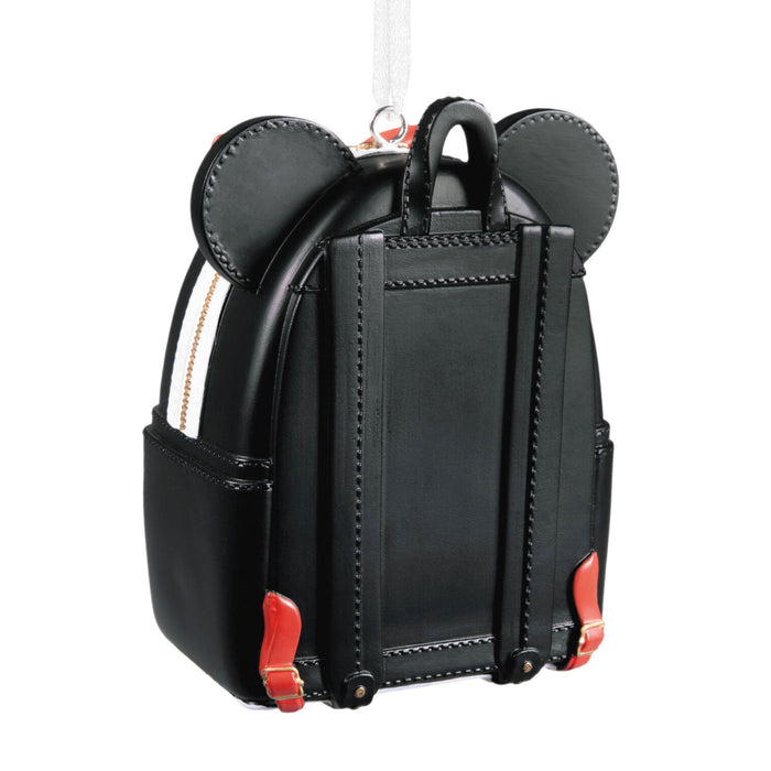 A black faux-leather Mickey Mouse-themed backpack shown from the back, featuring stitched mouse ears on top, a top handle, side pockets, and small red accents near the base, photographed on a white background.