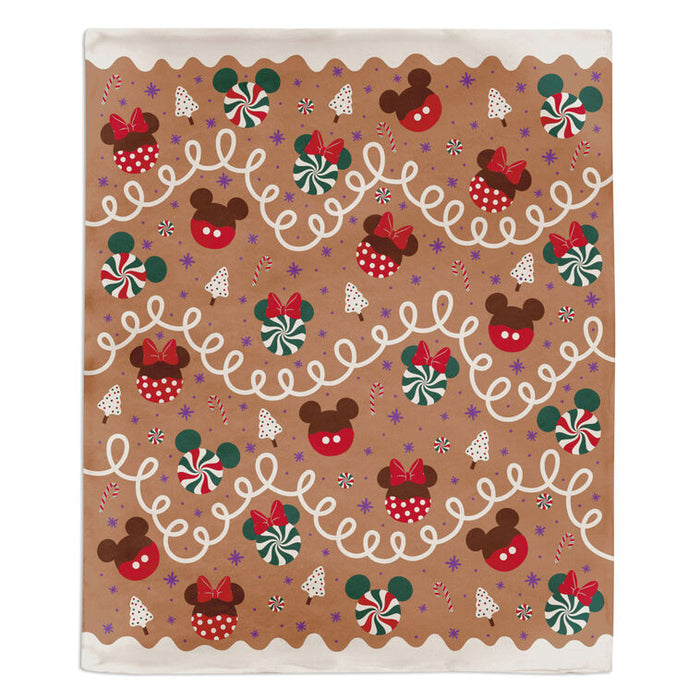 Gingerbread-themed wrapping paper with Mickey and Minnie Mouse designs on a brown background.