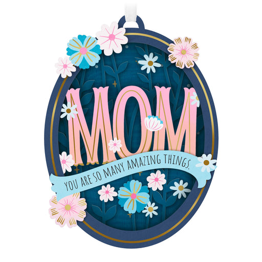 Decorative sign with 'Mom' and floral elements on a white background