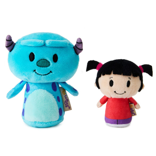 Two plush toys, one blue with purple horns and the other in a red outfit, on a white background.