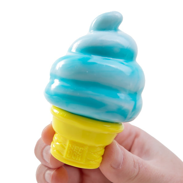 Toy ice cream cone with blue soft serve and yellow cone held by a hand on a white background