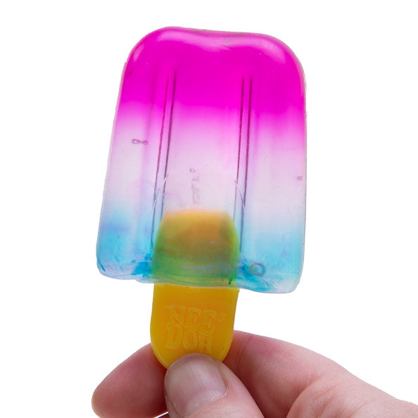 Colorful popsicle with a gradient from pink to blue held by a hand on a white background